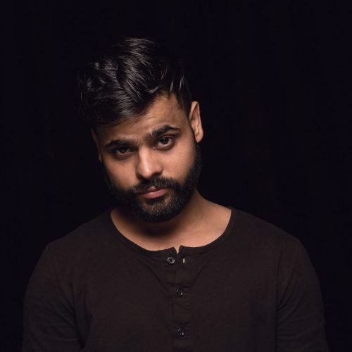 Close up portrait of young hindu man isolated on black studio background. Photoshot of real emotions of male model. Mourning, mental suffering. Facial expression, human nature and emotions concept.